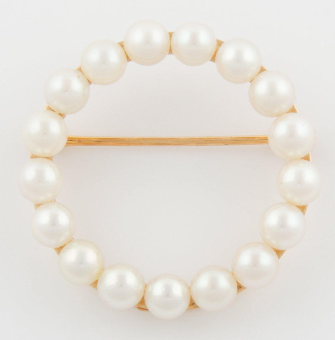Pearl Circle Pin in 14K Yellow Gold: Pearl Circle Pin in 14K Yellow Gold. Size: 1" x 1" (2.5 x 2.5 cm). 5.3 g. Since 1937, the The Silver Shop of Princeton, NJ was located at 59 Palmer Square West.