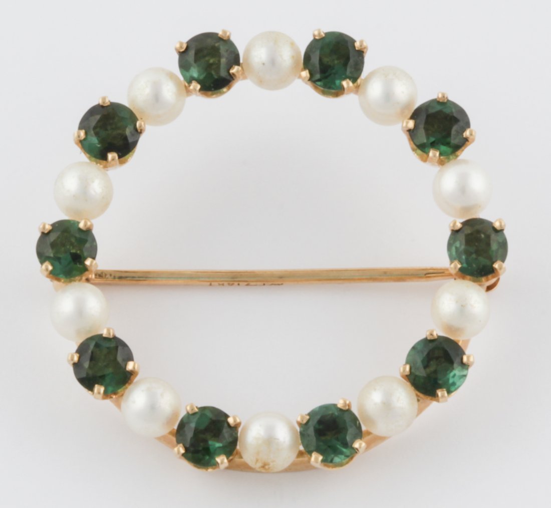 14K Gold, Emerald and Pearl Circle Pin: Gold, Emerald and Pearl Circle Pin marked 14K. 1.25"D (3 cm). 5.6 g. Since 1937, the The Silver Shop of Princeton, NJ was located at 59 Palmer Square West.