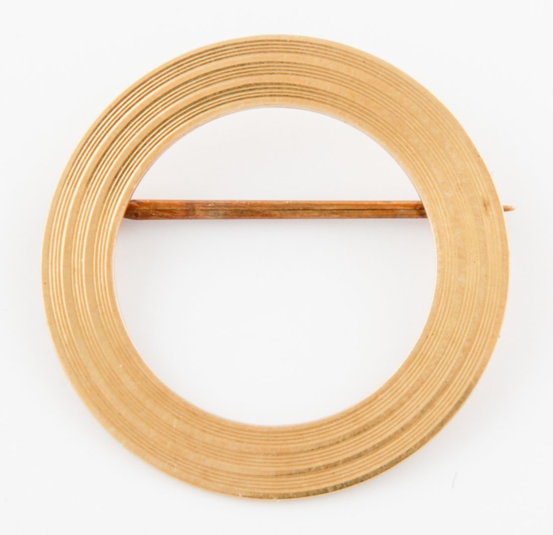 Fluted 14K Gold Circle Pin: Fluted Gold Circle Pin marked 14K. 1"D (2.5 cm). 2.5 g. Since 1937, the The Silver Shop of Princeton, NJ was located at 59 Palmer Square West.