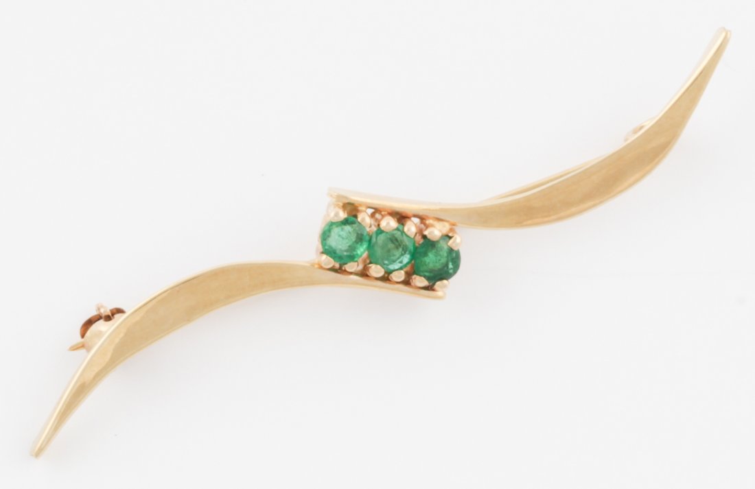14K Gold and Emerald Pin: Gold and Emerald Pin marked 14K signed TK. Size: 2"L (5 cm). 2.5 g. Since 1937, the The Silver Shop of Princeton, NJ was located at 59 Palmer Square West.