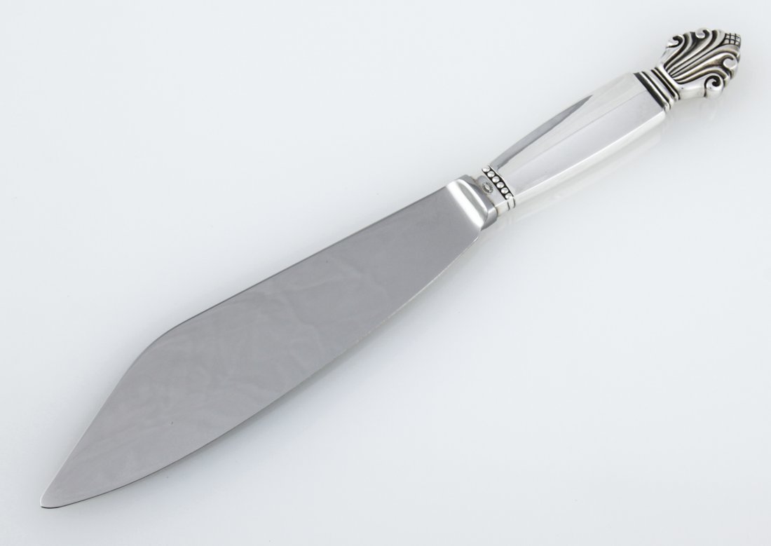 Georg Jensen Cake Knife: Georg Jensen Cake Knife. Stainless Steel Blade with Handle marked Sterling Denmark. Unused. 10.5"L (27 cm). Weight: 109.4 g . Since 1937, the The Silver Shop of Princeton, NJ was located at 59 Palmer 