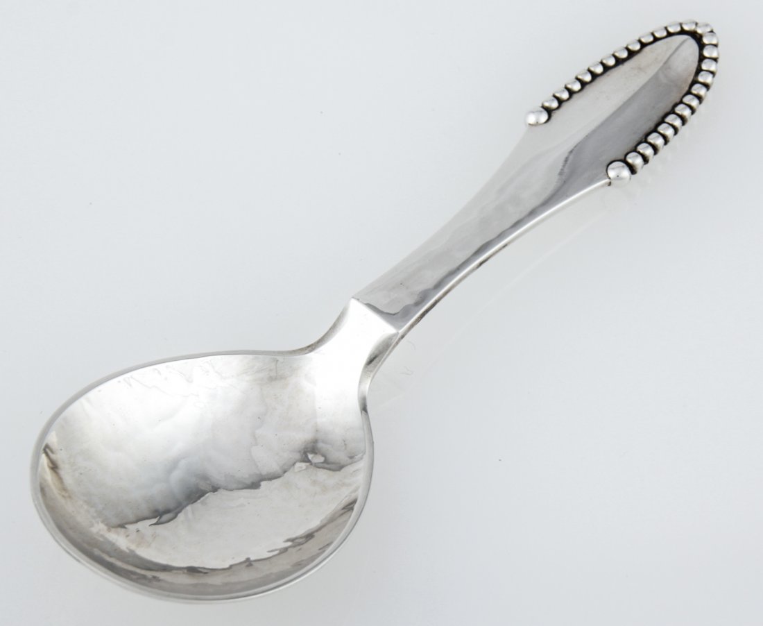 Georg Jensen Handwrought Silver Tea Caddy Spoon in the: Georg Jensen Handwrought Silver Tea Caddy Spoon in the "Beaded" Pattern marked Sterling. 4.5"L (11 cm). Weight: 33.2 g. Since 1937, the The Silver Shop of Princeton, NJ was located at 59 Palmer Square