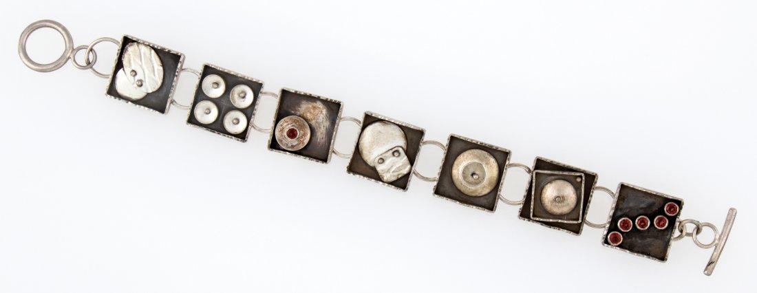 Handmade Kinetic Sterling Silver and Garnet Studio: Handmade Kinetic Sterling Silver and Garnet Studio Bracelet. Inset Moving Discs and Geometric Silver Elements signed A.Tate marked 925. 7.25"L (19 cm). Weight: 31 g. Since 1937, the The Silver Shop of