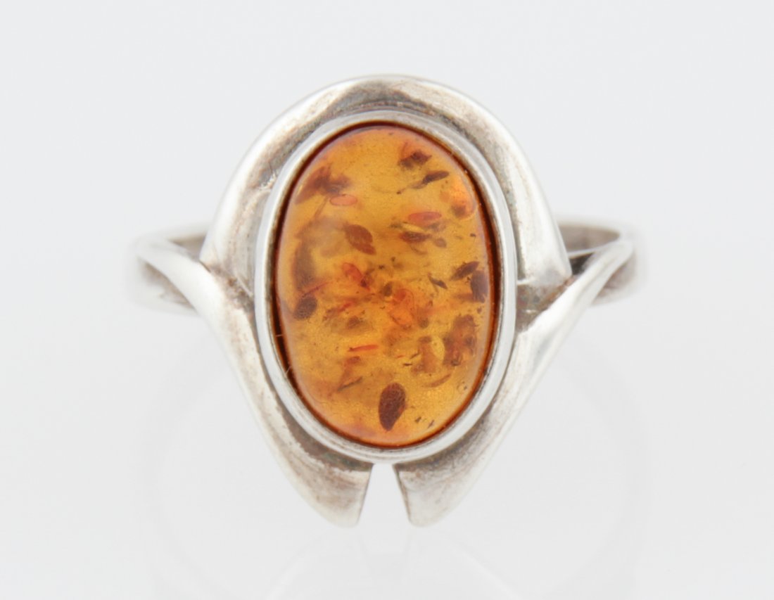 Sterling Silver and Bezel Set Oval Cabochon Amber Ring: Sterling Silver and Bezel Set Oval Cabochon Amber Ring marked 925. Size: 7. Weight: 3.9 g . Since 1937, the The Silver Shop of Princeton, NJ was located at 59 Palmer Square West.