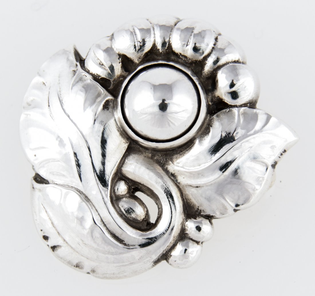 Georg Jensen Silver Brooch marked Sterling Denmark 71: Georg Jensen Silver Brooch marked Sterling Denmark 71. 1.5"D (4 cm). Weight: 9.7 g. Since 1937, the The Silver Shop of Princeton, NJ was located at 59 Palmer Square West.