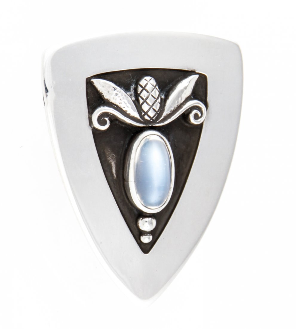 Georg Jensen USA Handmade Silver and Moonstone Brooch: Georg Jensen USA Handmade Silver and Moonstone Brooch. Marked 480 Sterling. 1.5" x 1.25" (4 x 3 cm) Weight: 13.2 g.Since 1937, the The Silver Shop of Princeton, NJ was located at 59 Palmer Square West