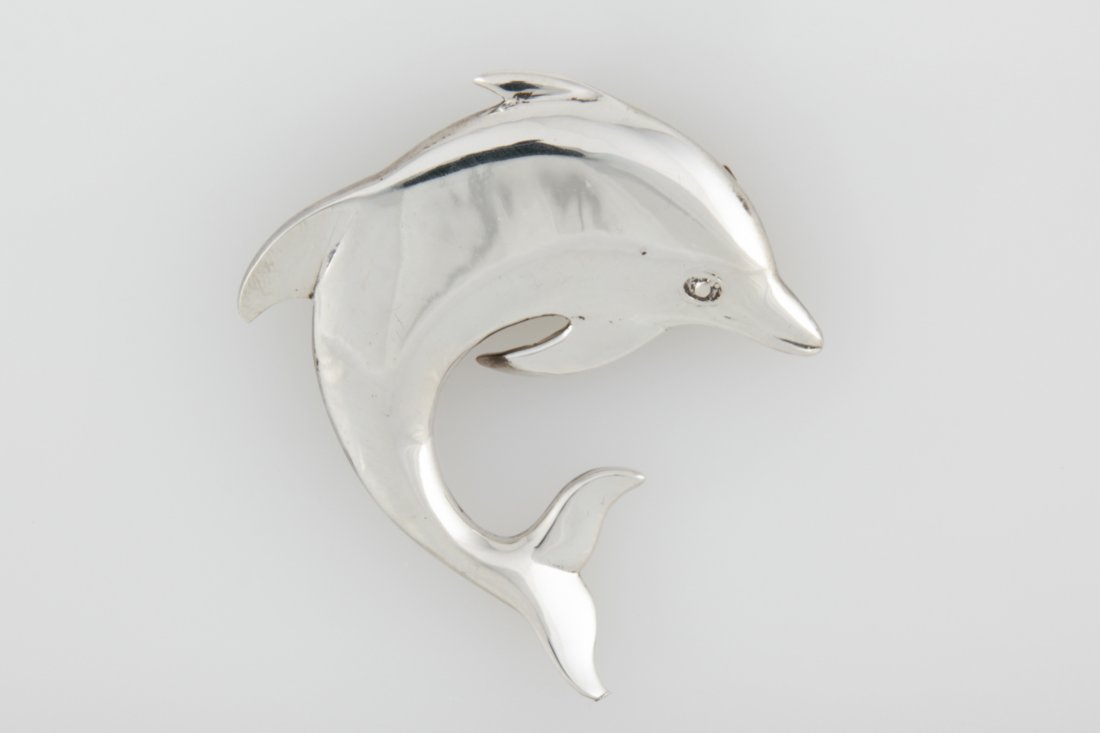 Large Silver Dolphin Brooch: Large Silver Dolphin Brooch marked Sterling "M". 2.75"L x 2.5"W (7 x 6 cm). Weight: 20.9 g. Since 1937, the The Silver Shop of Princeton, NJ was located at 59 Palmer Square West.