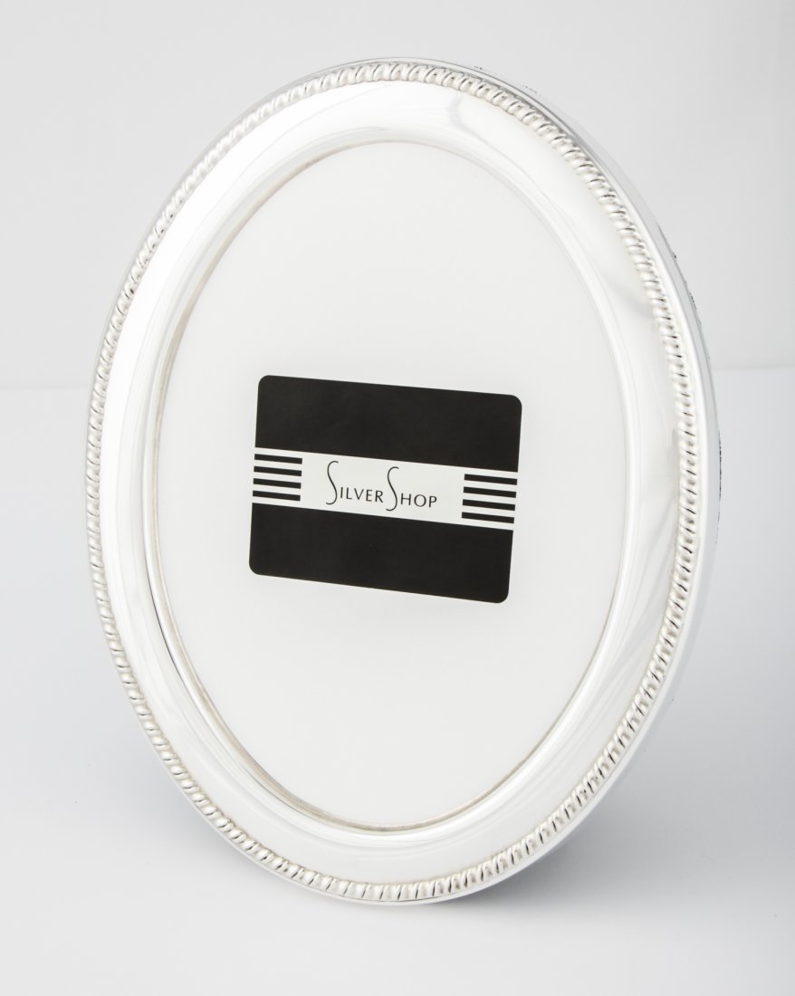 Sterling Silver Oval Frame: Sterling Silver Oval Frame, Velvet backed, for 5" x 7" (13 x 18 cm). Since 1937, the The Silver Shop of Princeton, NJ was located at 59 Palmer Square West.