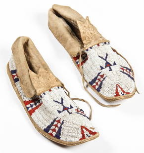 Pair of Plains Beaded Moccasins: Pair of Plains Beaded Moccasins. Length: 11" (28 cm). Seen pictured in early photo of Joe Grimm's collection. Provenance: Joseph Grimm, by descent to current owner Robert Panchison.