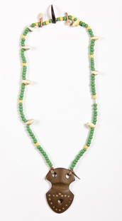 Plains Bead, Shell, Tooth, Claw and Carved Stone: Plains Bead, Shell, Tooth, Claw and Carved Stone Necklace. Length: 20" (51 cm). Stone medallion: 4" x 2.5" (10 x 6 cm). Provenance: Joseph Grimm, by descent to current owner Robert Panchison.