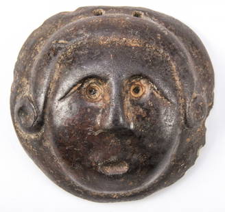 Ancient Cast Iron or Bronze Medallion of a Human Face: Ancient Cast Iron or Bronze Medallion of a Human Face, 2 pierced holes at top. Size: 2.75" x 2.75" x .875" (7 x 7 x 2 cm).