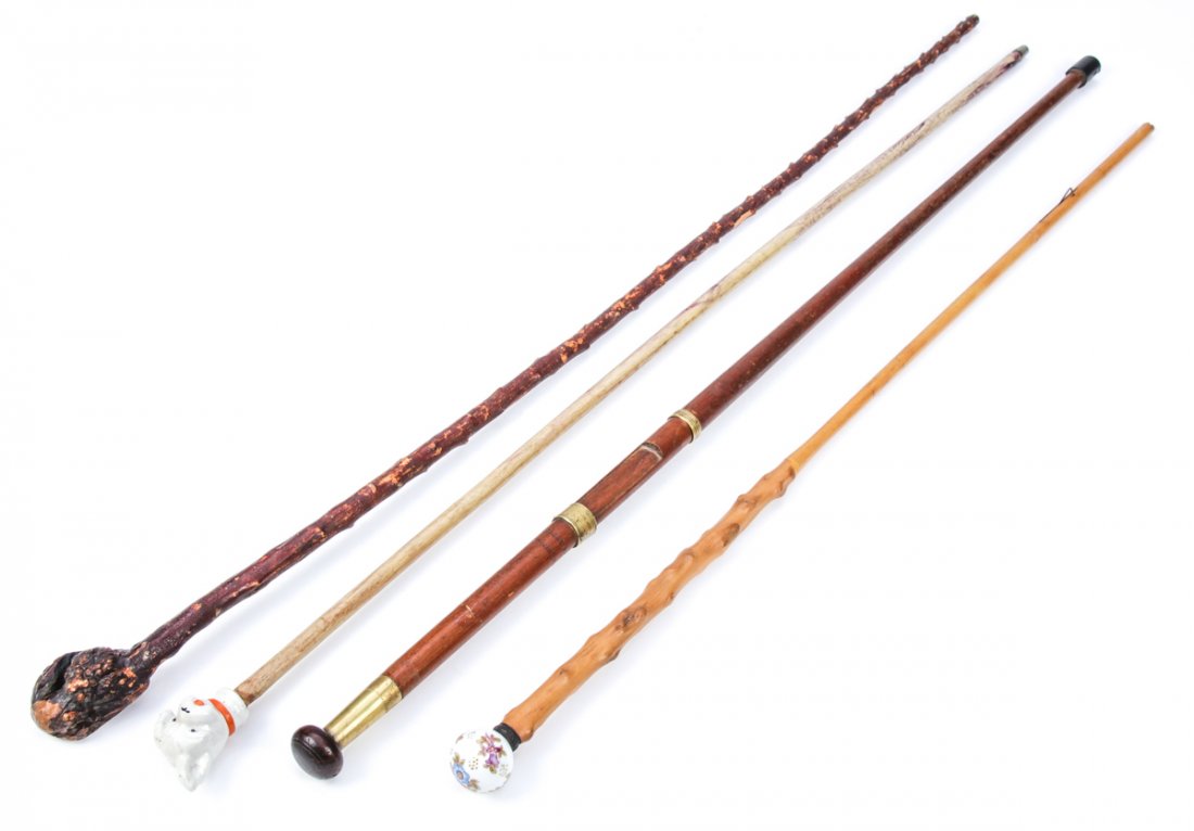 Group of 4 Antique Walking Sticks: Group of 4 Antique Walking Sticks. Consisting of 2 blackthorn sticks one of which was a parasol shaft, a carnival cane with a porcelain scottie dog finial, and a stick converted from the butt section 