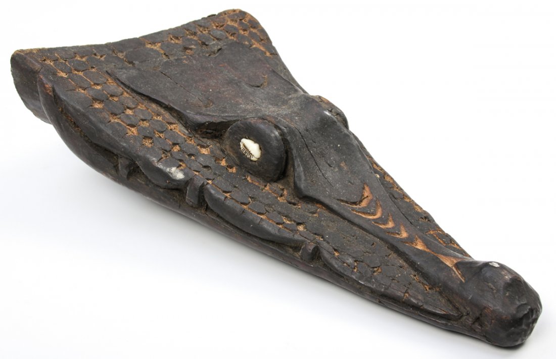 Sepik River Crocodile Canoe Prow: Sepik River Crocodile Canoe Prow, early 20th c., carved wood, inset cowrie shell eyes. Size: 16" x 9" x 3" (41 x 23 x 8 cm).