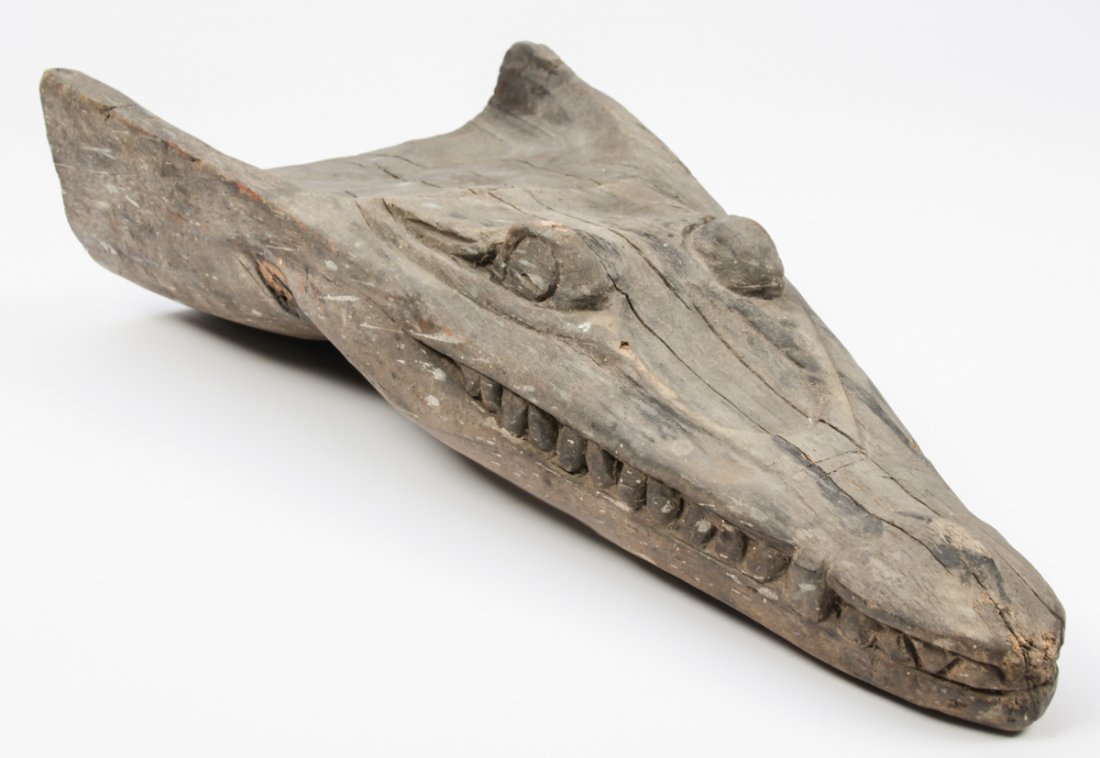 Sepik River Crocodile Canoe Prow: Sepik River Crocodile Canoe Prow, Papua New Guinea, early 20th c., carved wood, paint remnant. Size: 22" x 10" x 4.5" (56 x 25 x 11 cm).