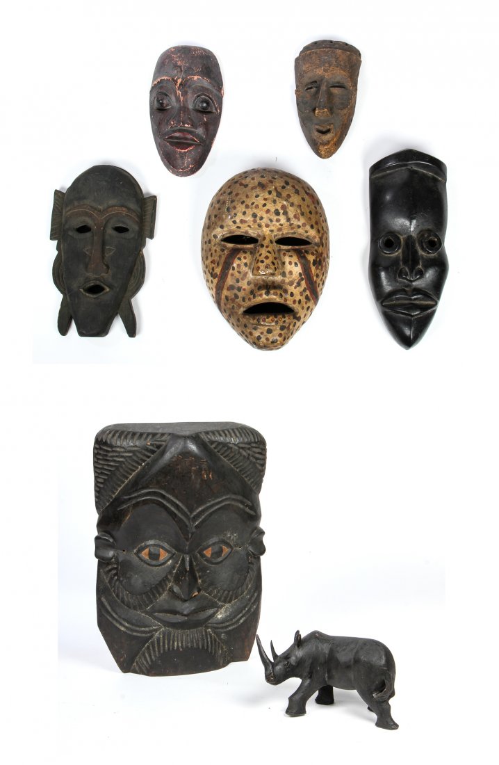 7 Pc African Lot of Carved Artifacts: 7 Pc African lot of carved artifacts: 1 ebony rhino, 3 tourist masks (Makonde and Senufo), 1 Kuba mask, 1 leopard mask and 1 Bete. Size: 21" x 14" x 4", 53 x 36 x 10 cm (largest).