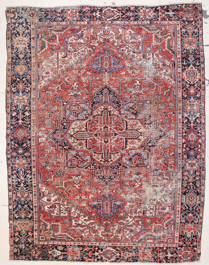 Heriz Rug: 8'10" x 11'7" (269 x 353 cm): Heriz Rug, Persia, early 20th c, shows significant wear. Size: 8'10" x 11'7" (269 x 353 cm).
