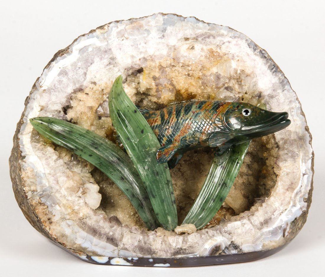 Folk Art Geode and Jadeite Figural Group: Folk Art Geode and Jadeite Figural Group. Carved jadeite Pike fish among grasses mounted in a geode backdrop. Size: 4.75" x 5.5" x 2" (12 x 14 x 5 cm).