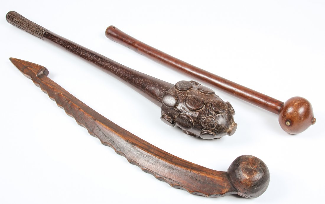 3 Indonesian and African Carved Wood Clubs: 3 Indonesian and African Carved Wood Clubs. Largest: 26" x 4" x 3" (66 x 10 x 8 cm).
