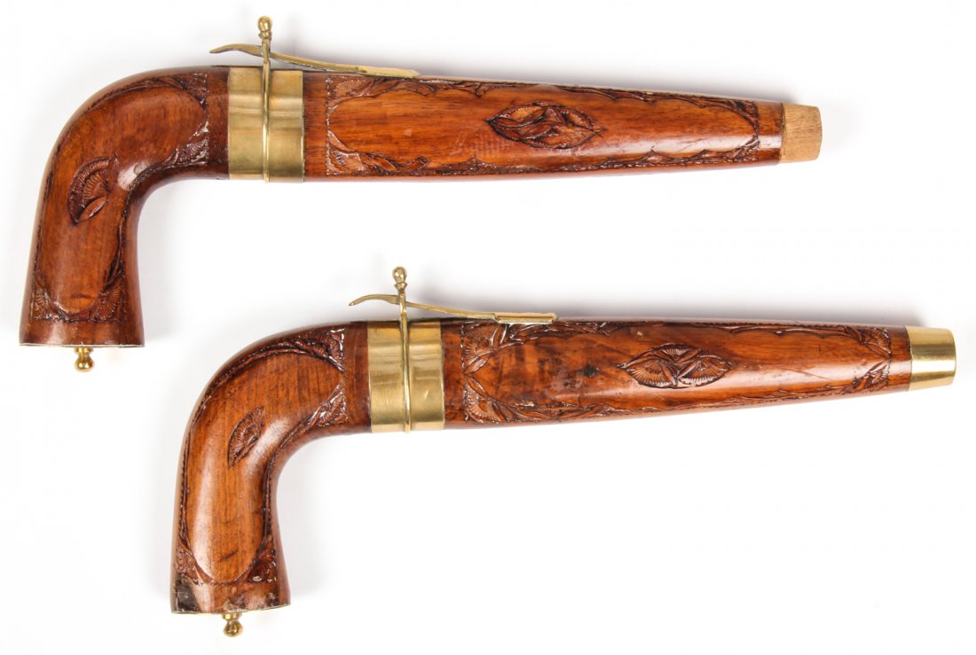 Indonesian pistol form carving set: Indonesian pistol form carving set. Size: 5" x 11" x 1.25", 13 x 28 x 3 cm (each). Provenance: Estate of Eileen Ford, Tewksbury, New Jersey.