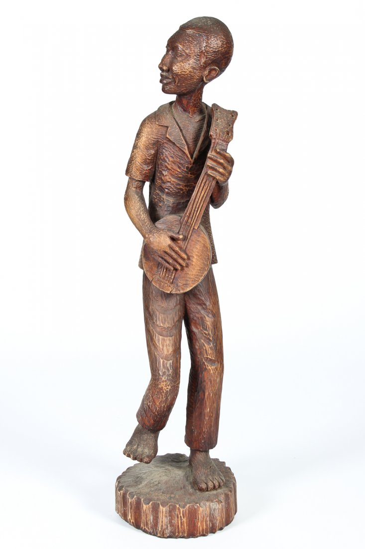 Haitian Carved Timber Minstrel: Haitian Carved Timber Minstrel. Signed Jacques Midi. Size: 32.5" x 7.5" x 8.5" (83 x 19 x 22 cm).