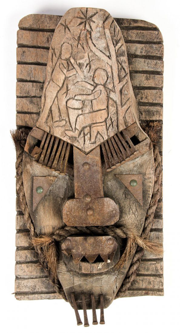 Haitian Carved Timber Mask: Haitian Carved Timber Mask. Carved and incised wood adorned with sheet metal and nails. Signed R. Michel. Size: 14.5" x 7.5" x 3.5" (37 x 19 x 9 cm).