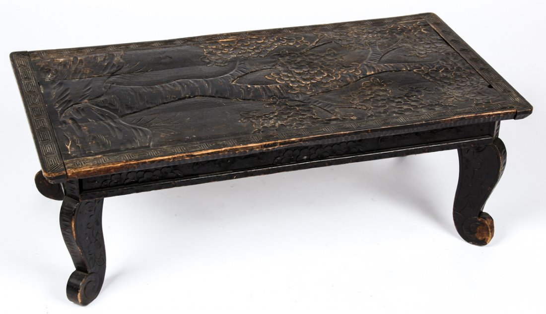 Relief Carved Japanese Low Table: Relief Carved Japanese Low Table. Ebonized wood featuring a singular cherry tree in bloom. Size: 12.25" x 35.5" x 18.5" (31 x 90 x 47 cm).