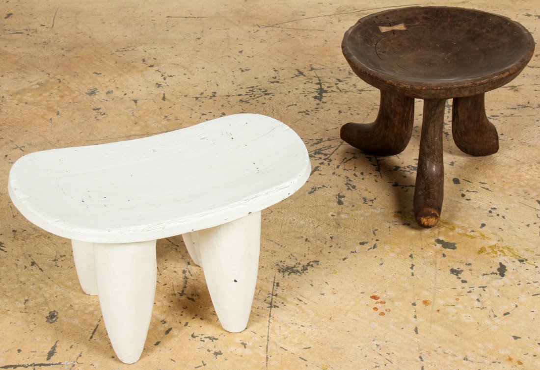 Decorator's Lot of Ethnographic Stools: Decorator's Lot of Ethnographic Stools. Consisting of a painted Lobi stool and a Turkana stool. Size: white stool 15" x 25" x 16.75" (38 x 63.5 x 42.5 cm). Estate of Sharon Simonaire, NYC.