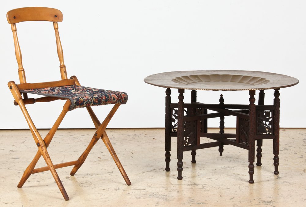 Civil War Chair and Turkish Brass Tray on Stand: Mixed Origins Chair and Table. Estate lot consisting of an American Civil War folding field chair by B.J. Harrison Son Co. and a chased Turkish tray on carved wood folding stand. Size: 32.5" x 16.5" x