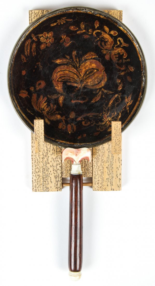 A Chinese Lacquered Silver Mirror, Ming Dynasty: A Chinese Lacquered Silver Mirror, Ming Dynasty, with wooden handle. Size: 8" x 4.25" x .5" (20 x 11 x 1 cm). Provenance: Estate of Robert Swan Lindsley and Eric Hoage, Philadelphia.