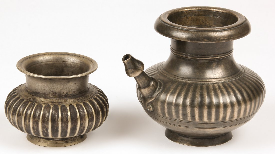 2 Black Bronze Vessels, Nepal, 1800-1850: 2 Black Bronze Vessels, Nepal, 1800-1850, including a heavy koruwa with pinched neck and ribbed sides; and a heavy bronze oil lamp. Largest Size: 5" x 5" x 6.5" (13 x 13 x 17 cm). Total weight: 1635 g
