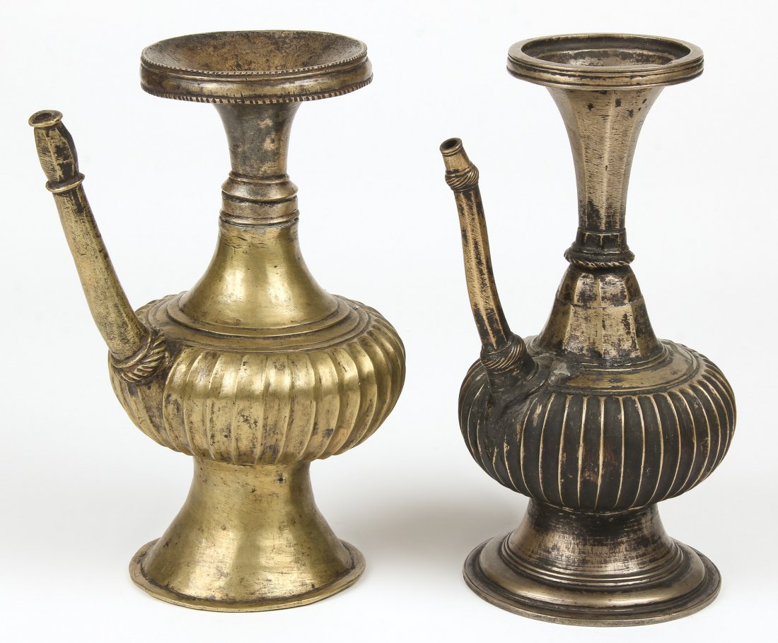 2 Fine 19th C Ewers: 2 Fine 19th C Ewers, Nepal, circa 1800-1850, including a black bronze ewer with ribbed sides, and a brass ewer also with ribbed sides. Largest Size: 10.5" x 5.5" x 7.5" (27 x 14 x 19 cm). Total weight