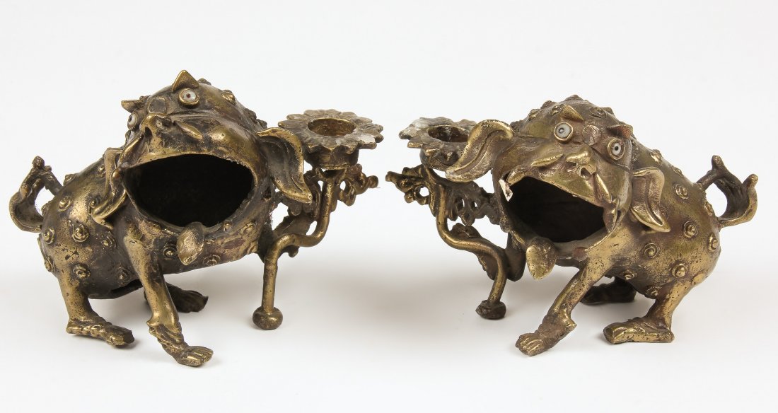 Pair of Foo Dog Bronze Candle Holders: Pair of Foo Dog Bronze Candle Holders, Nepal, early/mid 20th c. Largest size: 4.5" x 5" x 4.5" (11 x 13 x 11 cm). Total weight: 1060 grams. Provenance: Matthew Friedman Collection. Matthew Friedman is