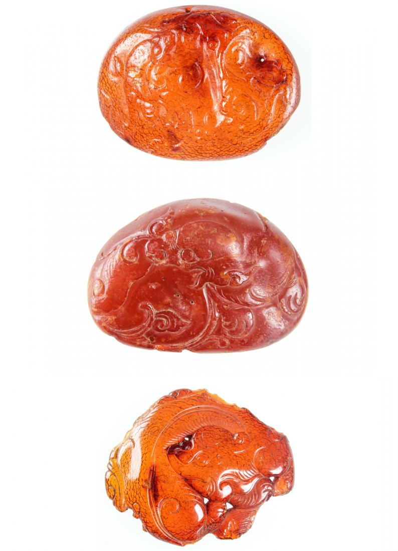 3 Antique Chinese Amber Amulets: 3 Antique Chinese Amber Amulets, Ming/Qing Dynasty. Sizes (top to bottom): 1) 1.5" x 2" (3.75 x 5 cm); 2) 1.5" x 2.25" (3.75 x 5.75 cm); 3) 1.75" x 2" (4.5 x 5 cm). Provenance: Piero and Paola Ferro.