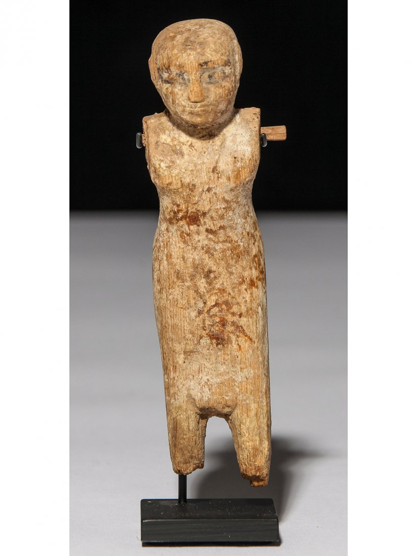 Ancient Egyptian Wooden Figure: Ancient Egyptian Wooden Figure. Middle Kingdom. Size: 5.25"H x 1.25"W, 13 x 3 cm (object); 5.75"H x 1.75"W, 15 x 5 cm (overall). Provenance: Bob Brand and Liz Werthan, Philadelphia.