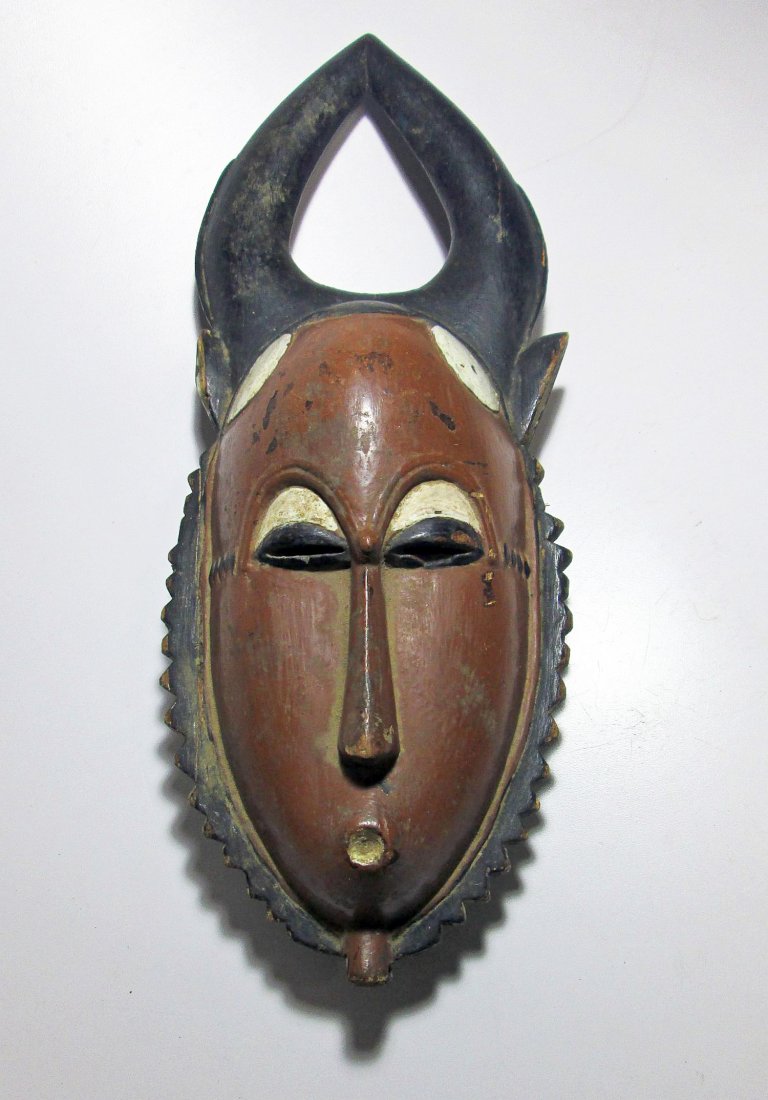 Old Painted Baule Mask with Horns, West Africa: Old Painted Baule Mask with Horns; an attractive old carved wooden mask with antelope style horns. Baule peoples, West Africa. Size: 15" x 6" (38 x 15 cm).