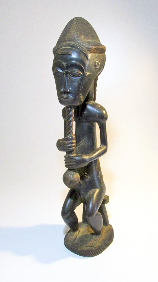 Finely Carved Baule Male Idol: Finely Carved Baule Male Idol. Old carved wooden Blolo Bian Spirit Husband from the Baule peoples, West Africa. Size: 22" x 5.5" (56 x 14 cm).