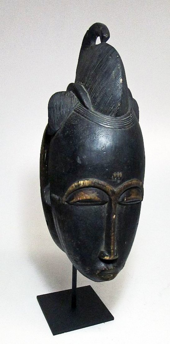 Old Baule Mask, West Africa: Old Baule mask. Well carved wooden face mask with classic facial treatment and style. Baule peoples, West Africa. Size: 16.5" x 7.5" (42 x 19 cm). Includes base.
