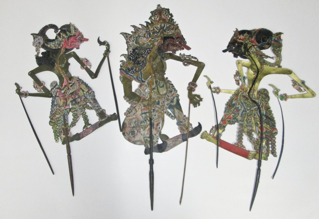 Three Antique Javanese Shadow Puppets: Three Antique Javanese Shadow Puppets. Vintage to antique Wayang Kulit or Shadow Puppets from Java, Indonesia. Carved buffalo hide with well worn wooden handles suggesting years of use. Size: 36" x 14