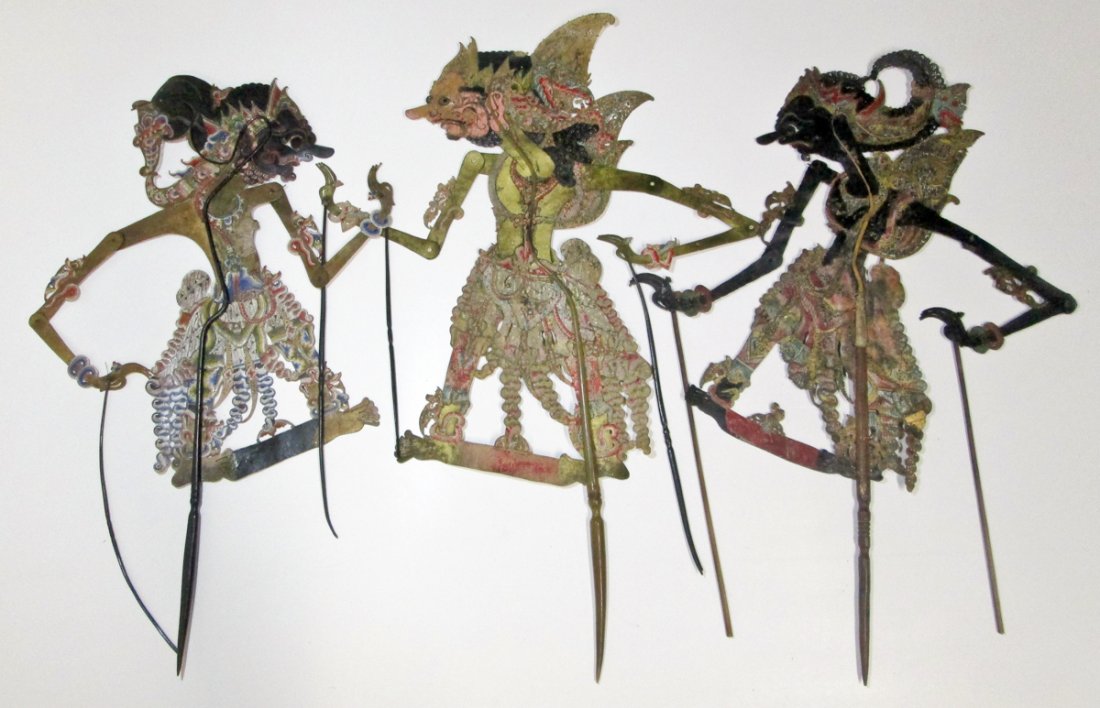 Three Antique Javanese Shadow Puppets: Three Antique Javanese Shadow Puppets. Vintage to antique Wayang Kulit or Shadow Puppets from Java, Indonesia. Carved buffalo hide with well worn wooden handles suggesting years of use. Size: 33" x 13