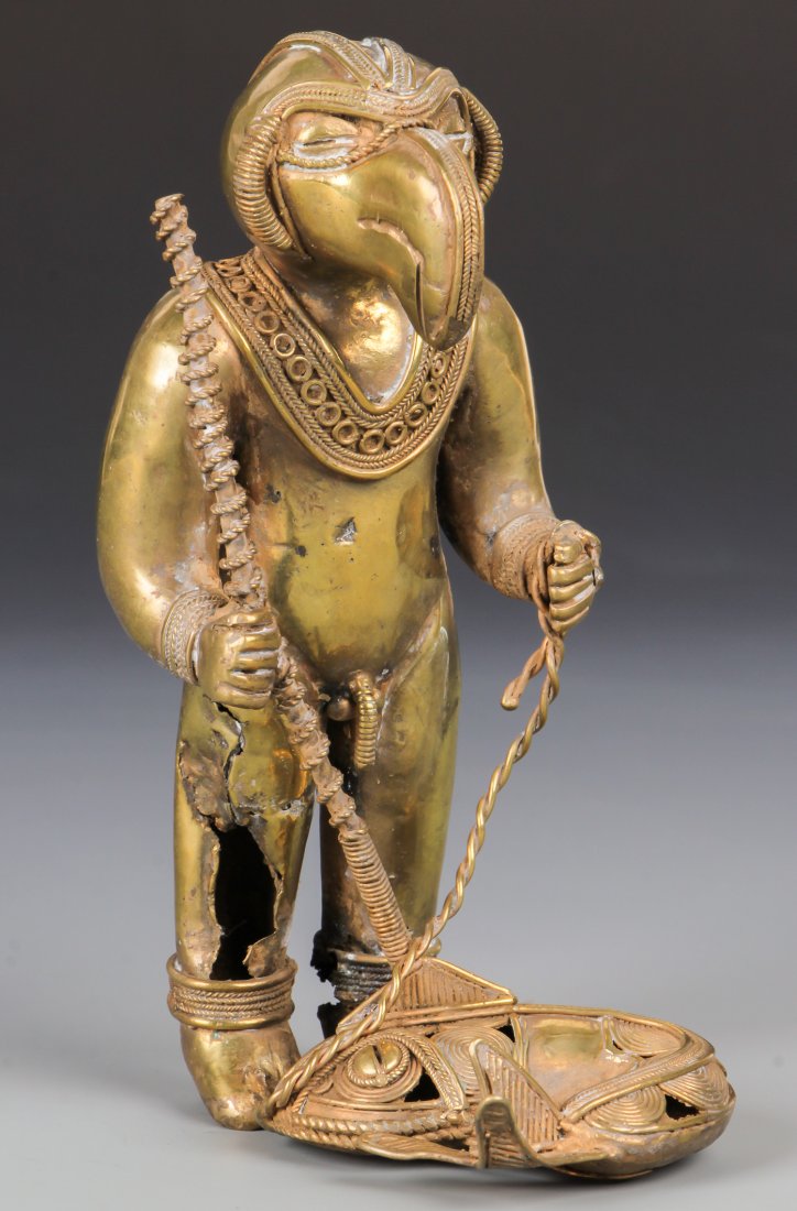Tairona Large Gold Alloy Shamanic Figure (1000-1500 CE): Tairona Large Gold Alloy Shamanic Figure (1000-1500 CE) as fisherman, slit trance eyes, phallus, spear and fish. Some casting damage to left leg. Size: 5.5" x 2" x 3.25" (14 x 5 x 8 cm).
