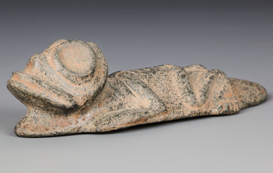 Taino Large Stone Frog-Man Pendant (1000-1500 CE): Taino Large Stone Frog-Man Pendant (1000-1500 CE). A stone (andesite) pendant of frog emerging from a skeletal shamanic body. Size: 1.5" x 1.5" x 5" (4 x 4 x 13 cm).