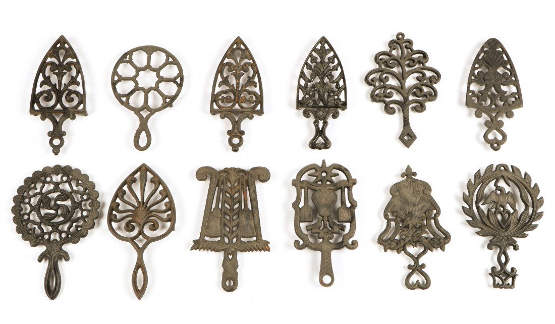 12 Antique Cast Iron Trivets: 12 Antique Cast Iron Trivets. Largest: .5" x 6" x 9.5" (1 x 15 x 24 cm).