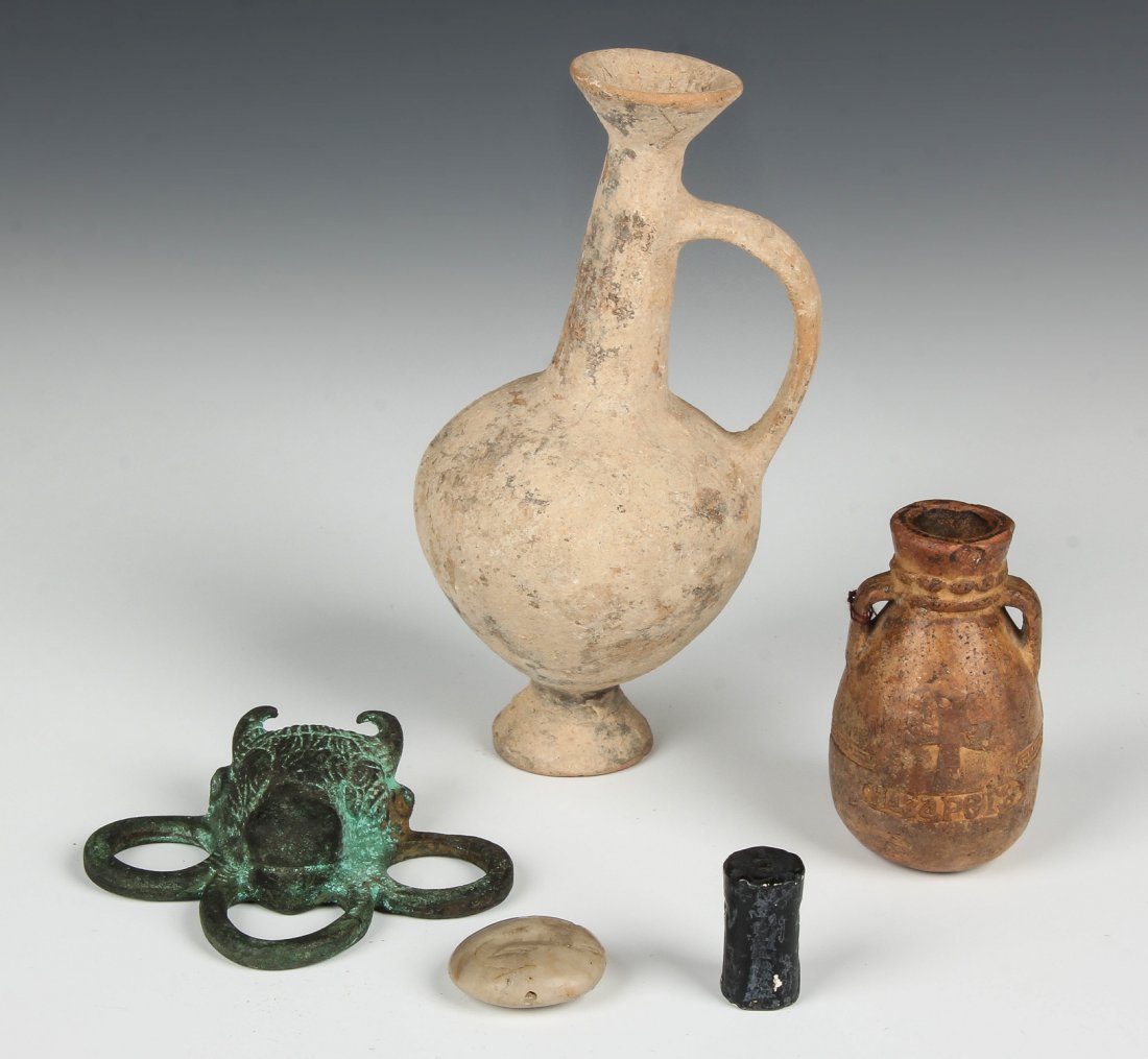 5 Roman and Near Eastern Antiquities: 5 Roman and Near Eastern Antiquities. Consisting of 2 seals, 2 earthenware vessels and bull protome buckle. Largest Size: 6'' x 3'' x 2.75'' (15 x 8 x 7 cm). Estate of Edward Soleimani, Englewood, NJ.