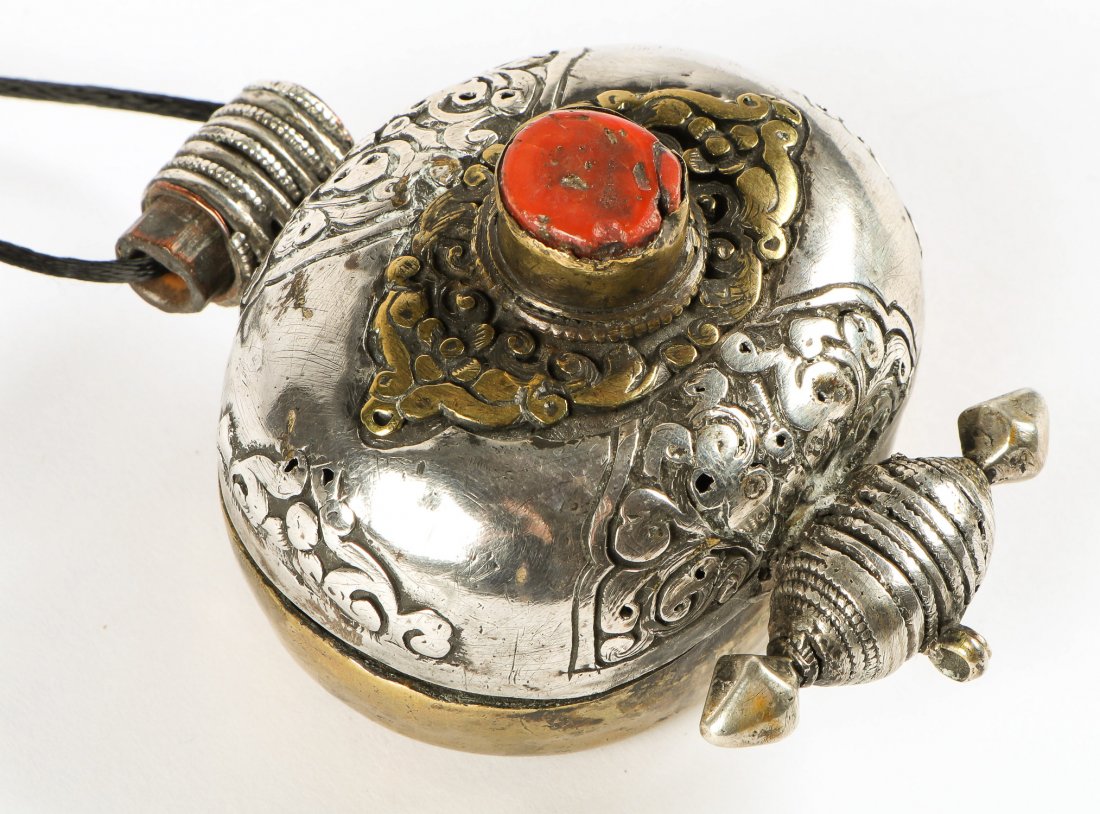 Tibetan Gau Reliquary Pendant: Tibetan Gau Reliquary Pendant. Silver, brass and coral. Size: 1.75" x 3.5" x 2.5", 4 x 9 x 6 cm. Provenance: Maryanne Conheim, Philadelphia.