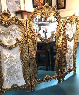 24k Gilded Wood 3 Panel Screen w/ Mirror: Unique and unusual three panel 24k gold gilded wood screen or room divider with cherub accents. A cherub is on the top on each side panel and cherub scenery depicted with flowers. The middle screen