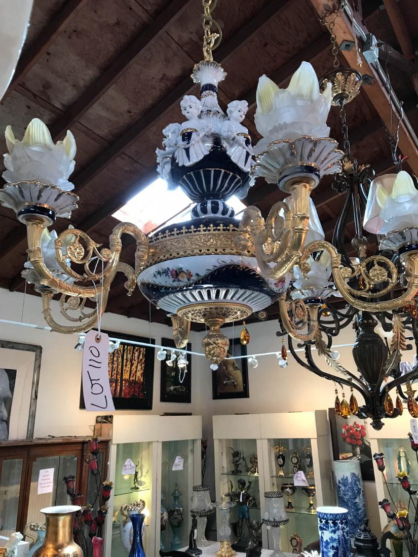 Porcelain and 24k Gold Gilded Chandelier w/ Angels: Beautiful cobalt blue and white porcelain chandelier with 24k gold plate bronze with angels depicted and handpainted floral design. There are six lights with frosted glass cups. In good condition. Mea