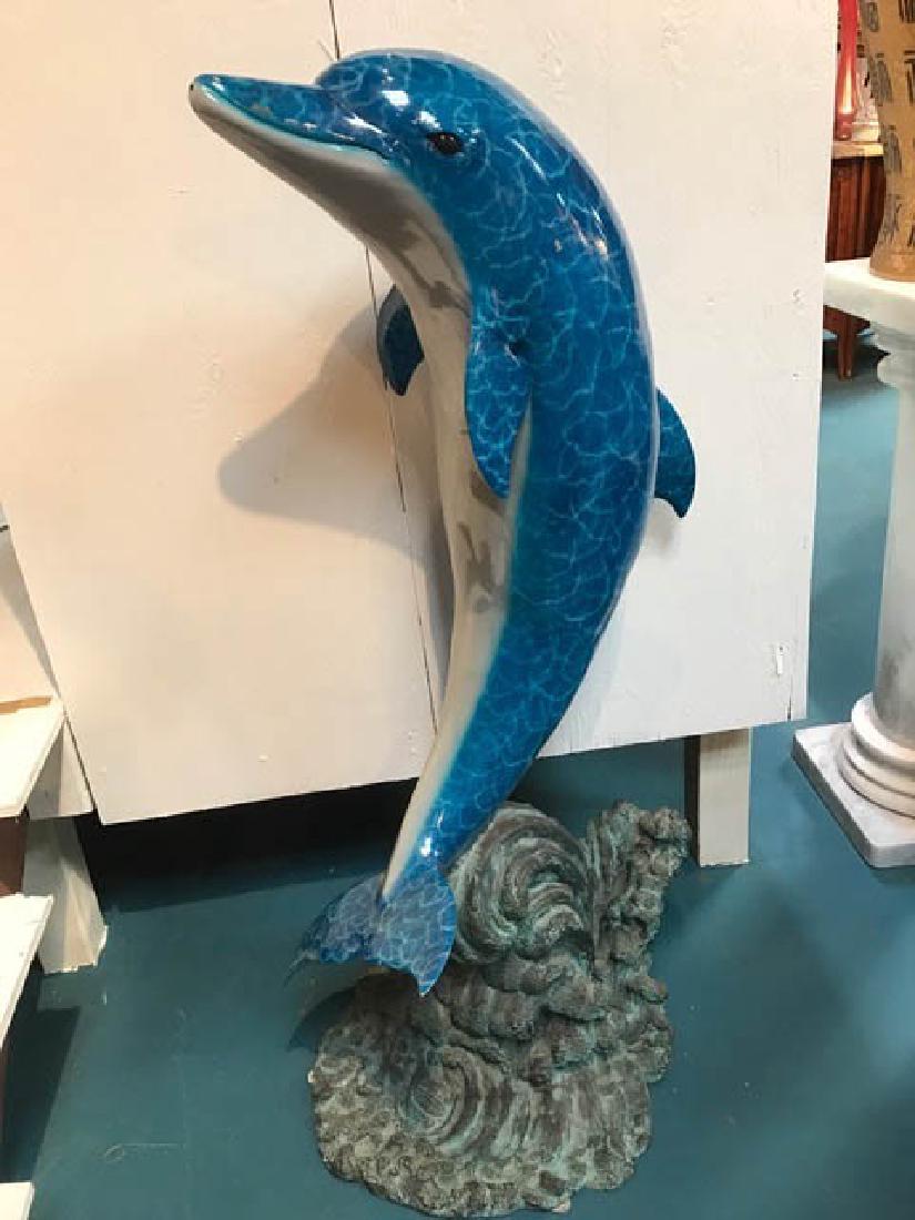 Bronze Dolphin Fountain with Dual Patina: Bronze dolphin on top of a wave fountain. Dual patinated with magnificent color. Holes on bottom and water shoots out of dolphin's mouth. Measures approx. 50" H x 28" W x 21" D.