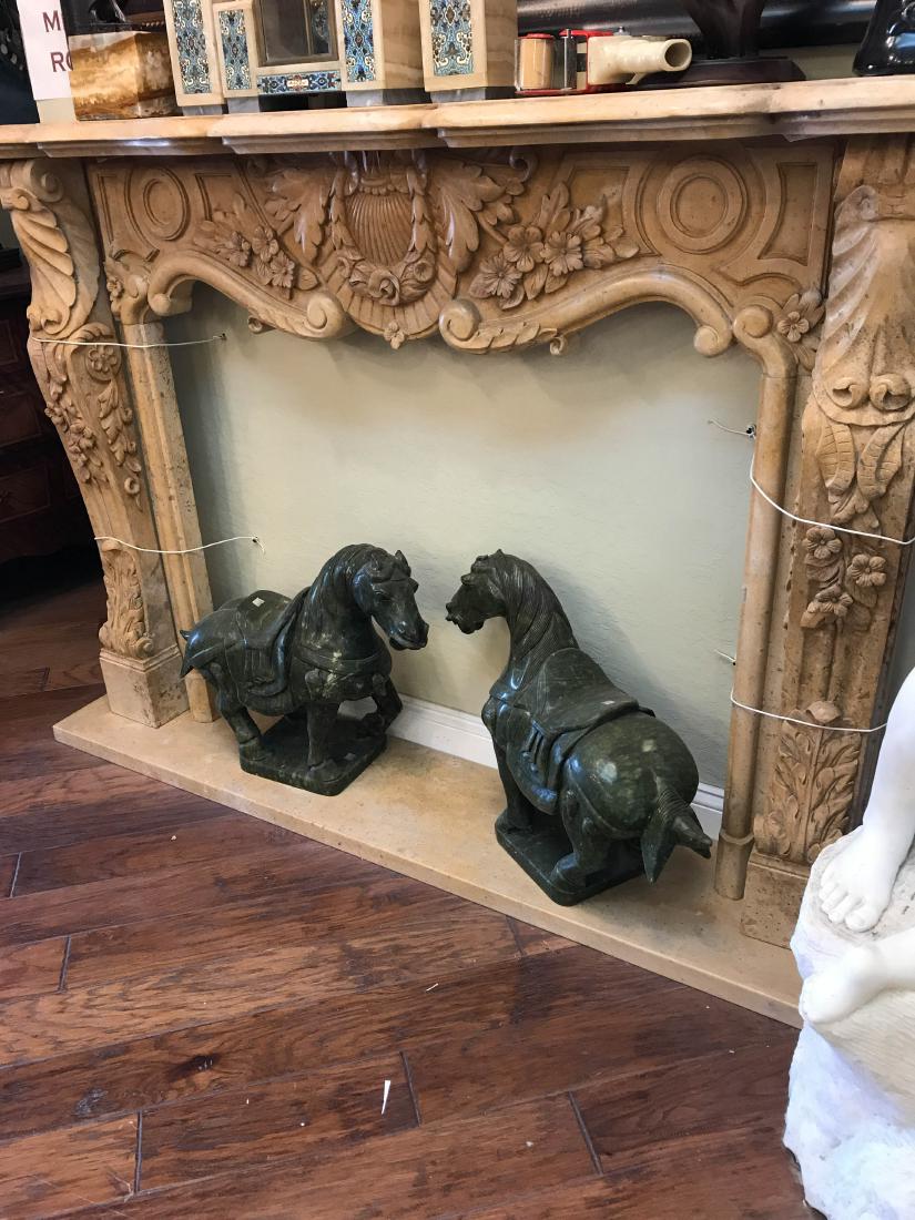 Hand Carved Marble Fireplace: Handcarved travertine colored marble fireplace. Carved with exceptional details. In good condition. Measures approx. 48"H x 66"W x 13"D