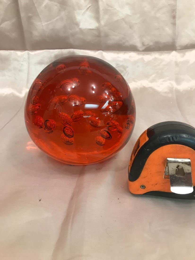 Large Round Orange Glass Paperweight: Large paperweight with bubbles inside orange in color. Measures approx. 6"H x 7"W