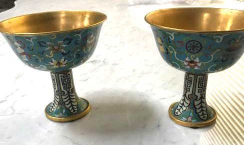Pair of Unique Cloisonne Cups w/ Floral Design: Pair of unique cloisonne cups with floral design and gold wash, Mark on bottom. Each measures approx. 6"H x 6 1/4"W.